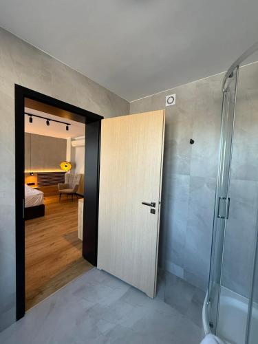 a bathroom with a shower and a sliding door at Hotel Martex in Płońsk