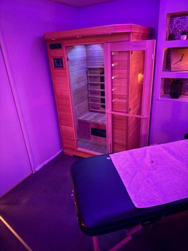 a purple room with a bed and a closet at Maison avec Spa Privatif, Jacuzzi et Sauna in Bailleval