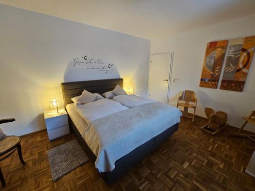 a bedroom with a large bed in a room at Ferienhaus Distelfink Gudensberg Urlaub in der Mitte von Deutschland documenta 16 in Gudensberg