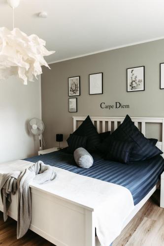 a bedroom with a large white bed with blue sheets at HOME AM SEE Ferienwohnung in Möhnesee