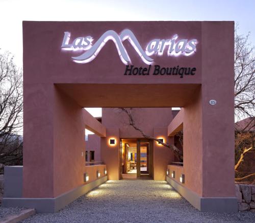 a hotel building with a neon sign on it at Las Marías Hotel Boutique in Tilcara