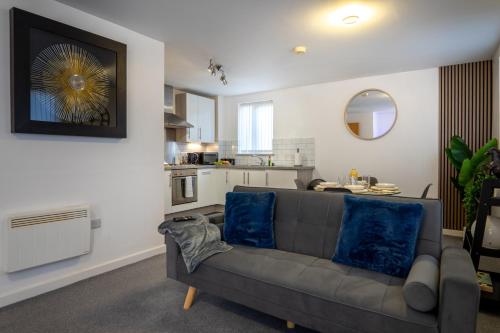 a living room with a couch and a kitchen at The Beauchamp Modern 2BR Coventry City Centre Apt Free Parking in Coventry
