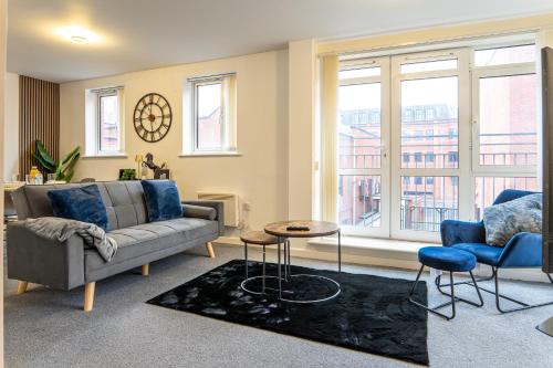 a living room with a couch and a table at The Beauchamp Modern 2BR Coventry City Centre Apt Free Parking in Coventry