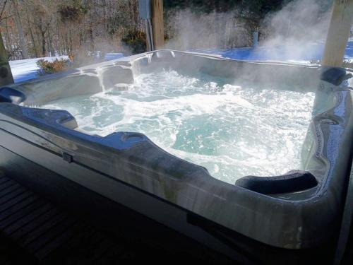 a hot tub with steam coming out of it at Westcott House- Privacy, amenities and space all in one beautiful package! in Luray