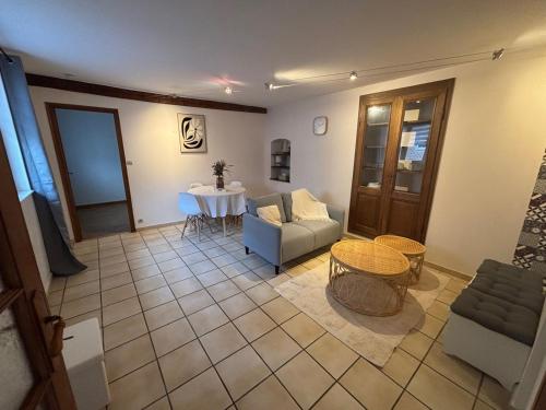 a living room with a couch and a table at L'écrin de Cambrai - Appt 40 m² centre Cambrai in Cambrai