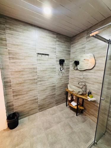 a bathroom with a shower and a sink at Montis Resort in Yeghegis
