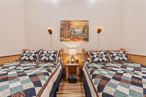 two beds sitting next to each other in a room at Historic Yellowstone Saloon in Ashton