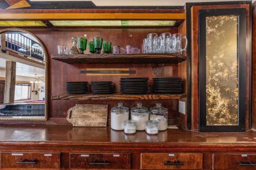 a room with a counter with jars and a mirror at Historic Yellowstone Saloon in Ashton