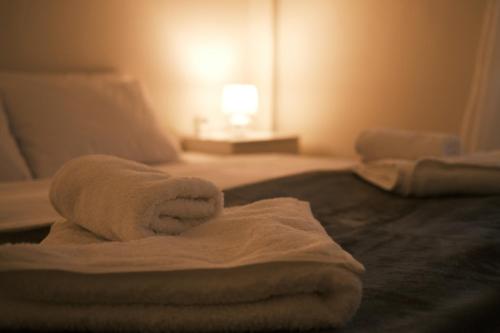 a towel on a bed in a hotel room at The Sunny Side Apartment in Florina