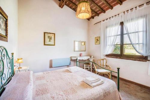 a bedroom with a bed and a table in it at Agriturismo Rebarco in Borsecchio