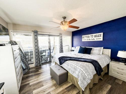 a bedroom with a bed and a blue wall at Blueys Lakefront 2 Bed and 2 Bath Condo in Abbeyville