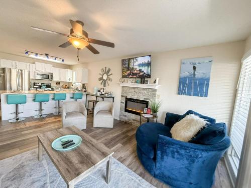 a living room with a blue couch and a table at Blueys Lakefront 2 Bed and 2 Bath Condo in Abbeyville