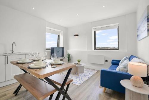a living room with a table and a blue couch at City centre FREE Parking Families and Contractors Sleeps 5 with a view in Norwich