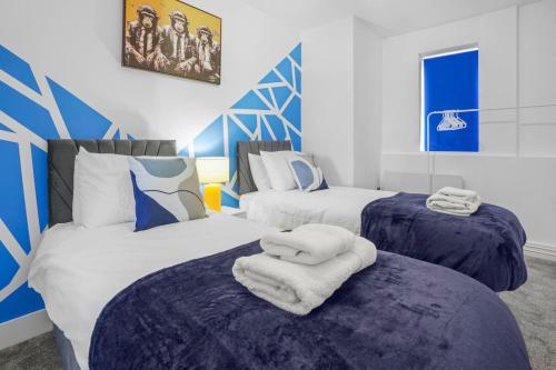 two beds in a room with blue and white at City centre FREE Parking Families and Contractors Sleeps 5 with a view in Norwich