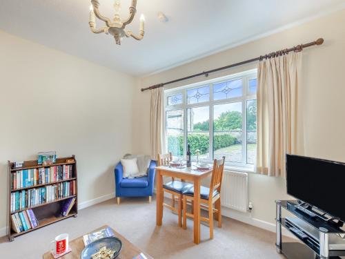 a living room with a table and a window at Polly's Fold in Grassington