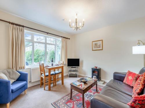 a living room with a couch and a table at Polly's Fold in Grassington