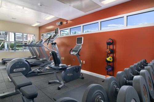a gym with treadmills and ellipticals in a room at The DeSoto in Savannah