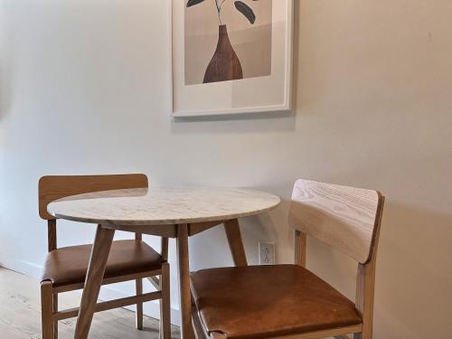 a table and two chairs and a table and a picture at Modern Studio, Gym, Near UAB in Birmingham