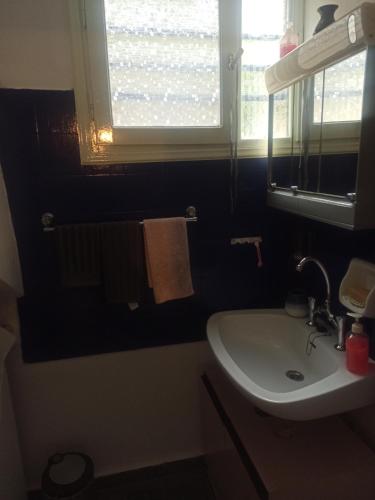 a bathroom with a sink and a window and towels at FAVIEROS-The secret Garden in Mesochórion
