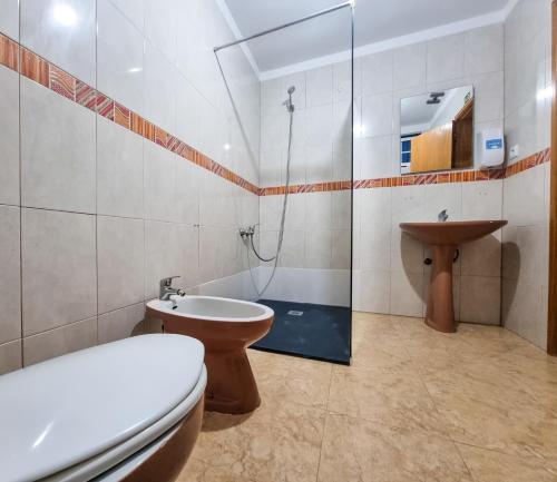 a bathroom with a toilet and a sink and a shower at Casa Martins by Tear in Aldeia de João Pires