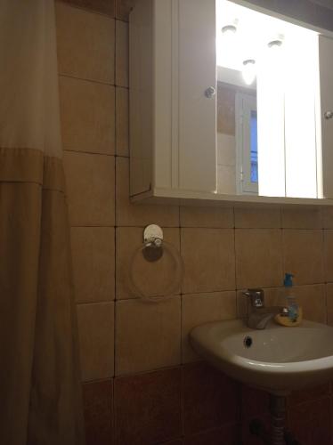 a bathroom with a sink and a mirror at Studio in Selínia