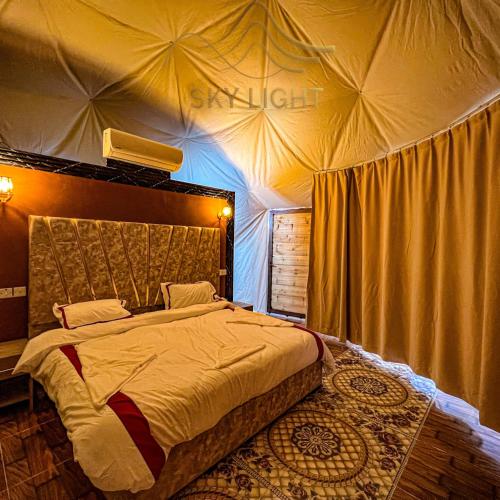 a bedroom with a large bed in a tent at Skylight Wadi Rum Camp in Disah