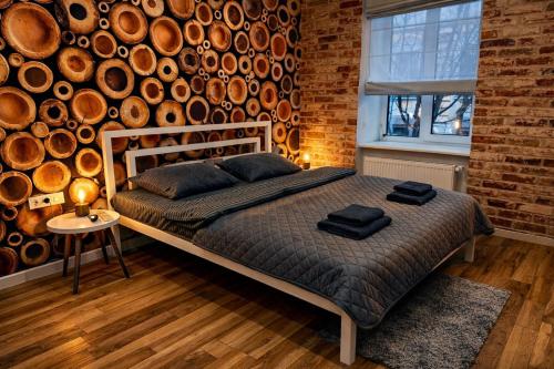a bedroom with a bed and a brick wall at Kobylianska-Premium 2 Room in Chernivtsi
