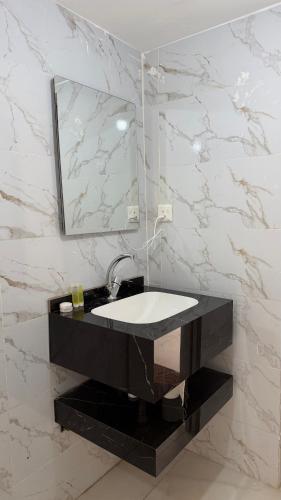 a bathroom with a sink and a mirror at RUM NADINE LUXURY CAMP & Bubbles Hotel in Wadi Rum