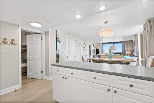 a kitchen with white cabinets and a dining room at SunDestin Resort Unit 1018 in Destin