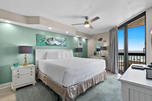 a bedroom with a bed and a desk with a computer at SunDestin Resort Unit 1018 in Destin