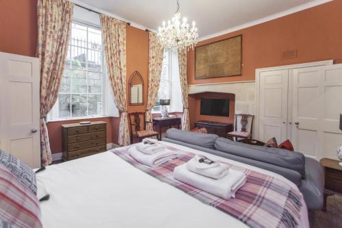 a bedroom with a large bed and a couch at 1 Bed in Bath oc-bhr34 in Bath