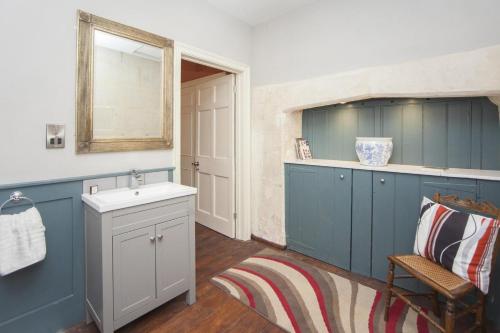 a bathroom with blue cabinets and a sink and a mirror at 1 Bed in Bath oc-bhr34 in Bath