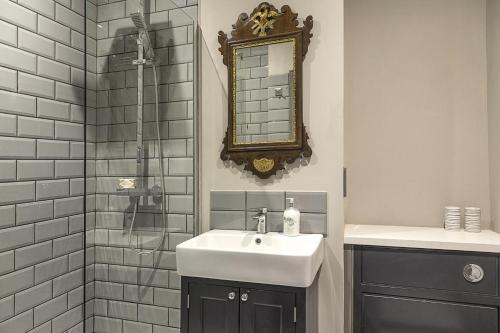 a bathroom with a sink and a shower with a mirror at 1 Bed in Bath oc-bhr33 in Bath