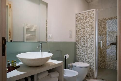 a bathroom with a sink and a toilet at Palazzo Dei Dondoli in Lecce