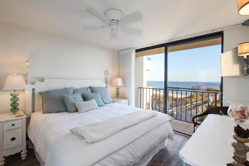a bedroom with a bed with a view of the ocean at One Seagrove Place 0205 in Santa Rosa Beach
