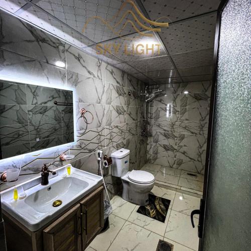 a bathroom with a sink and a toilet at Skylight Wadi Rum Camp in Disah