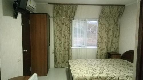 Cama o camas de una habitación en Uyutny Dom