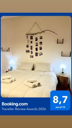a bedroom with a white bed with books on the wall at Appartamento Homemade privato a due passi dal centro in Biella