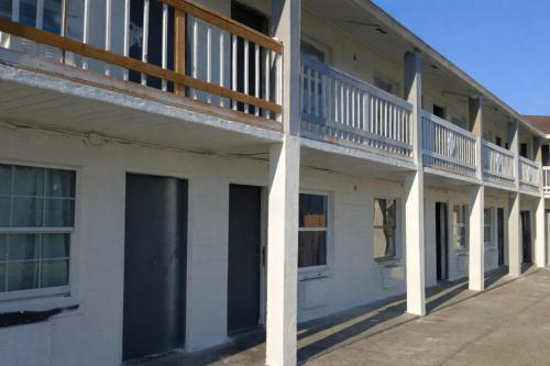 a white building with balconies on the side of it at Siesta Motor Inn Kissimmee Near Disney World in Kissimmee