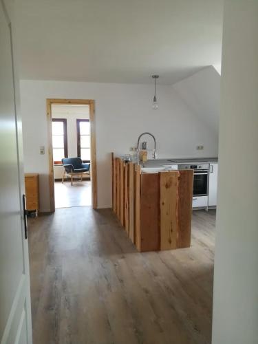 a kitchen with an open floor plan with a counter at Ferienwohnung in Möllenhagen