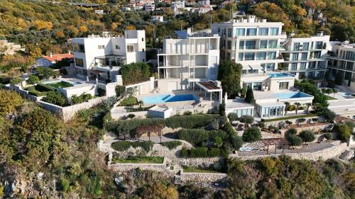 an aerial view of a building on a mountain at Luxury Seafront Villa Rezevici in Reževići