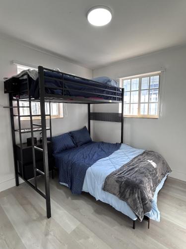 a bedroom with a bunk bed with blue sheets at Sweet home in Miami in Miami