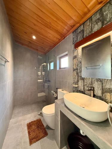 a bathroom with a sink and a toilet at Shan Star Weligama in Weligama