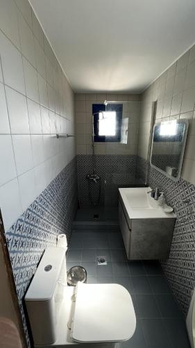 a bathroom with a toilet and a sink at Camaraki Capitano House , Chora Serifos in Serifos Chora