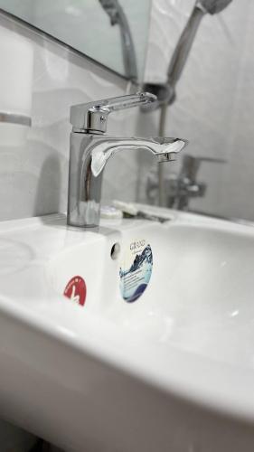 a bathroom sink with a toothbrush sitting on it at Welcome to Villa Yaaxya in Bukhara