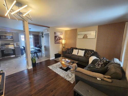 a living room with a couch and a table at Cozy 3-Bedroom Haven, Private Pool & Parking ! in Longueuil