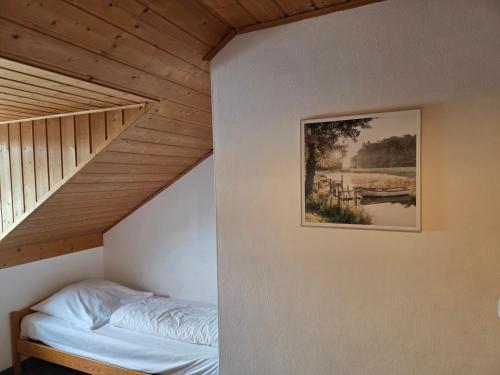 a bedroom with a bed and a picture on the wall at Apartmentanlage am Kellerberg in Zandt
