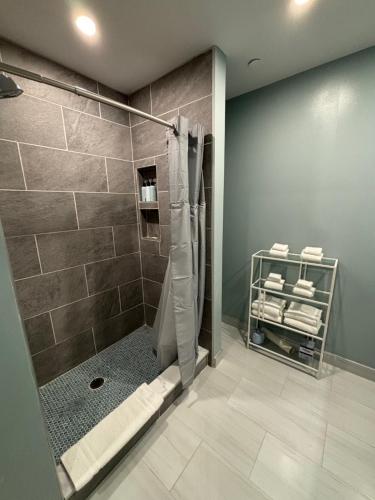 a bathroom with a shower with a glass door at Seaport Suites in Wildwood