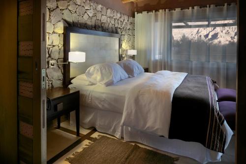 a bedroom with a large bed and a window at Las Marías Hotel Boutique in Tilcara