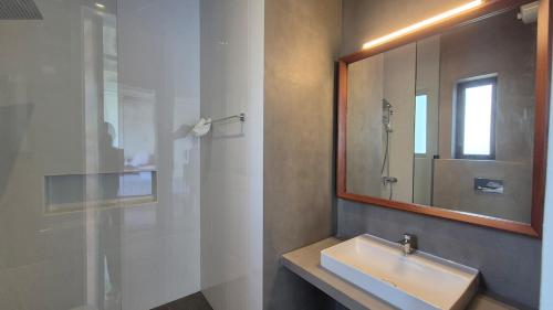 a bathroom with a sink and a mirror at Stillwater Edge 2 - Level Two in Sri Jayewardenepura Kotte